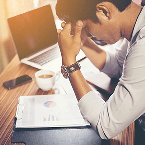 Man looking concerned at paperwork with chart on it