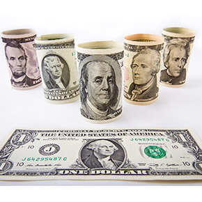 5 rolled dollar bills - one roll each of $2, $5, $10, $20, $50 and a $1 bill laying flat in front of those rolled behind