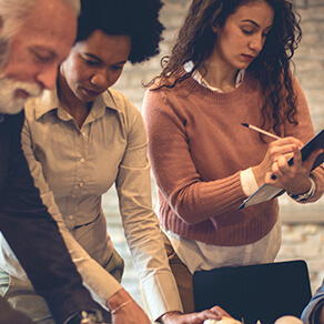 Three businesspeople working in office setting together